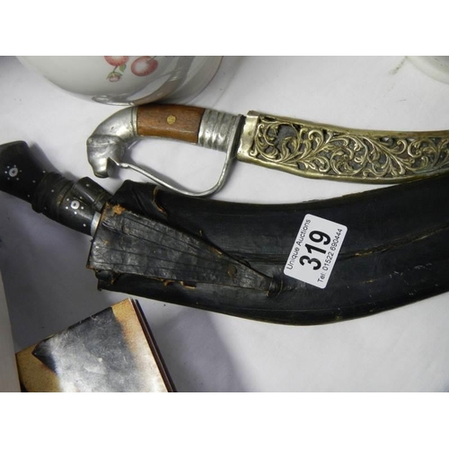 319 - A kukri and one other knife.