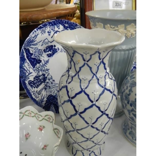 335 - Two blue and white plates, two vases and a lidded jar,. COLLECT ONLY.