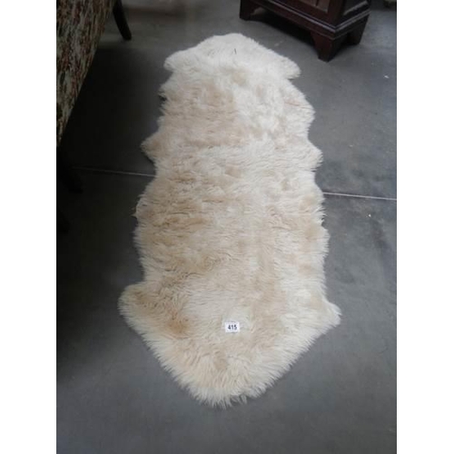 415 - A sheepskin rug.