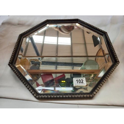 102 - An octagonal bevel edged mirror, COLLECT ONLY.