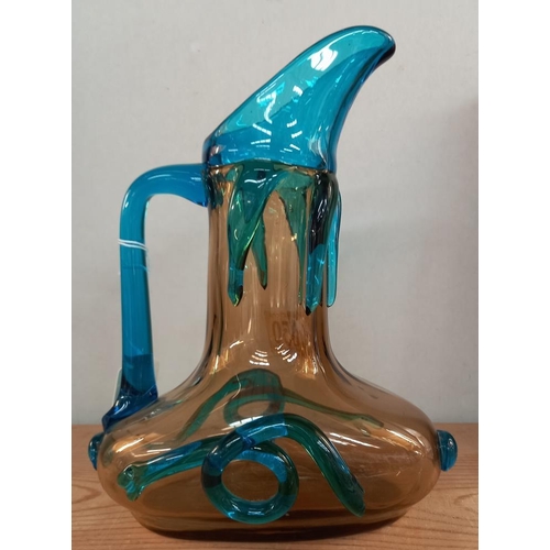 1050 - A late 19th/early 20th century, handblown glass wine jug, yellow ground with cobalt blue handle and ... 