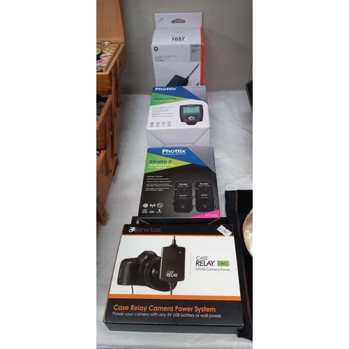 1057 - A quantity of boxed (as new) camera accessories including Phottix Odin II TTL flash transmitter, Pho... 