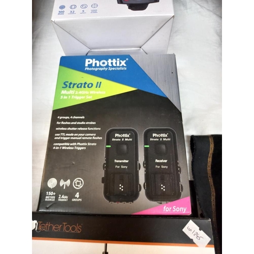 1057 - A quantity of boxed (as new) camera accessories including Phottix Odin II TTL flash transmitter, Pho... 