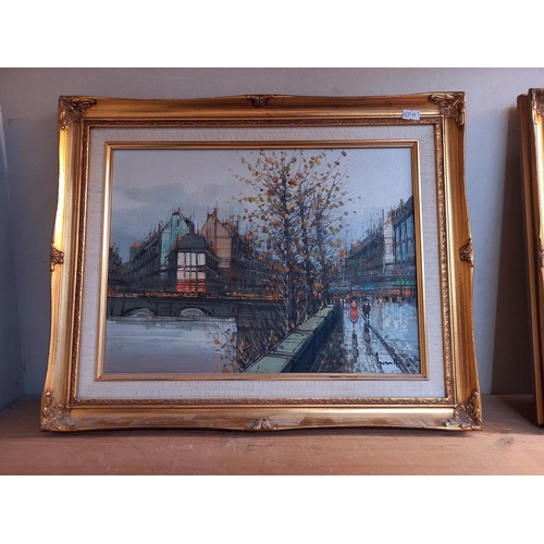 1072 - 2 stylized oil on canvas of street scenes in gilt frames COLLECT ONLY