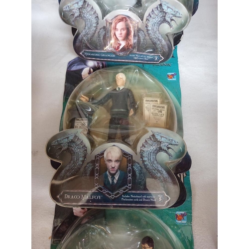 135 - 4 Harry Potter figures sealed in bubble packs and some collectors cards