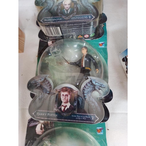 135 - 4 Harry Potter figures sealed in bubble packs and some collectors cards