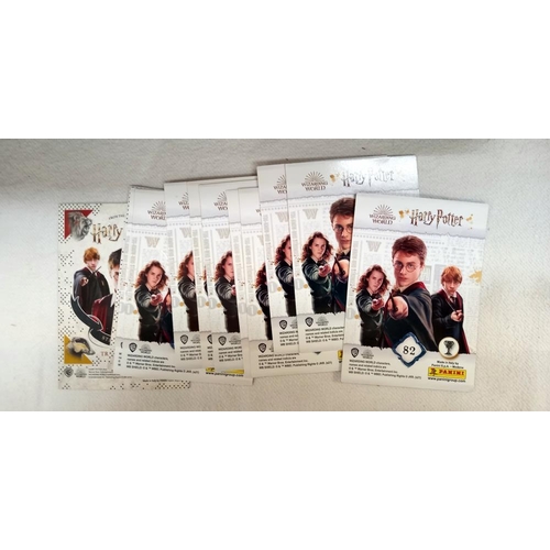 135 - 4 Harry Potter figures sealed in bubble packs and some collectors cards