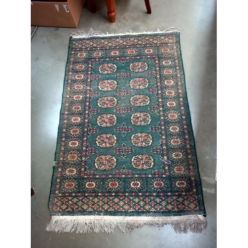 94 - An old green wool rug, 80cm x 135cm COLLECT ONLY