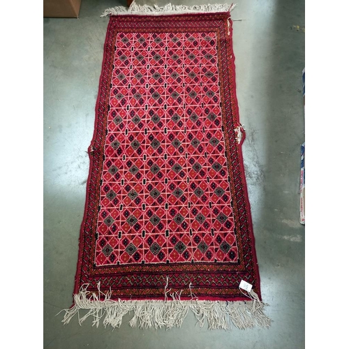 95 - An old red wool rug, 61cm x 140cm COLLECT ONLY