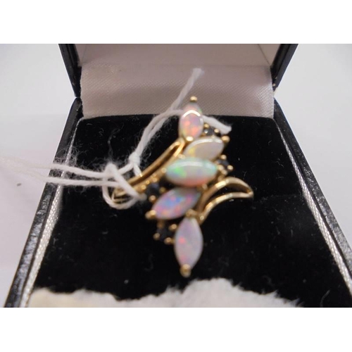 1020 - A 9ct gold ring set five opals, size R, 3 grams.