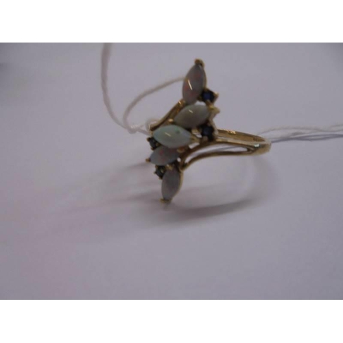 1020 - A 9ct gold ring set five opals, size R, 3 grams.