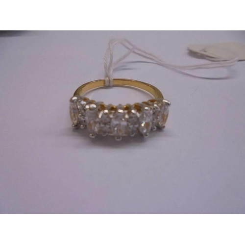 1025 - A yellow metal ring set clear stones, size R.