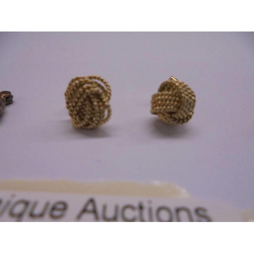 1026 - Two pairs of 9ct gold earrings (4 grams) and a pair of yellow metal earrings.