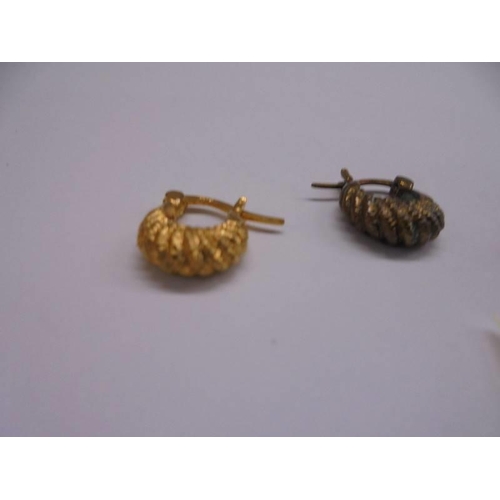 1026 - Two pairs of 9ct gold earrings (4 grams) and a pair of yellow metal earrings.