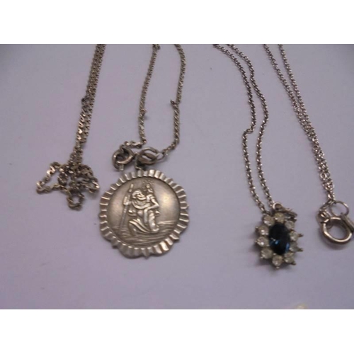 1035 - A silver St. Christopher and a silver pendant, 8 grams.