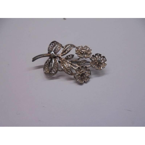 1037 - Three silver floral spray brooches and one other. 18.5 grams.