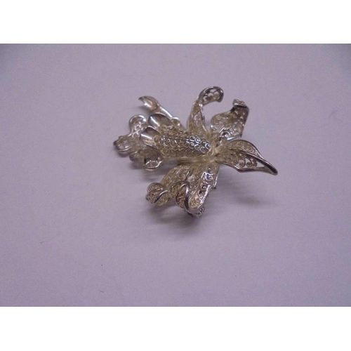 1037 - Three silver floral spray brooches and one other. 18.5 grams.