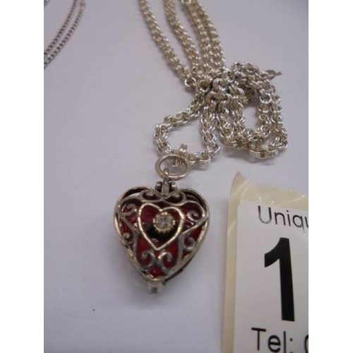 1040 - A silver heart pendant and a silver locket, 26.5 grams.