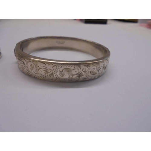 1042 - Three silver bangles, 51 grams.