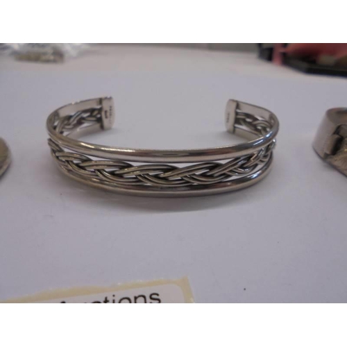 1042 - Three silver bangles, 51 grams.