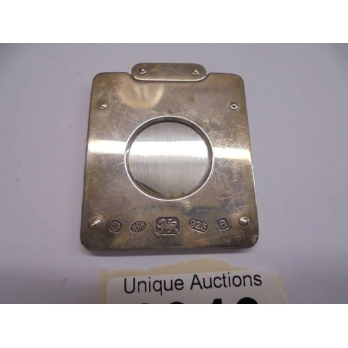 1046 - A hall marked silver cigar cutter.