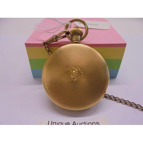 1051 - A gold plated half hunter pocket watch on chain, in working order.