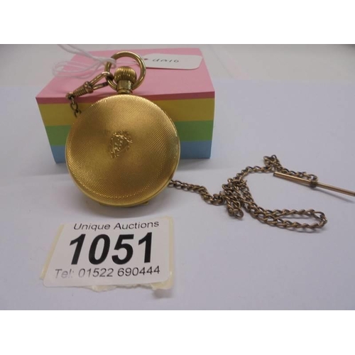 1051 - A gold plated half hunter pocket watch on chain, in working order.