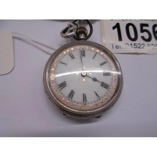 1056 - A Victorian ladies silver fob watch on silver chain, in working order, (chain 17 grams).