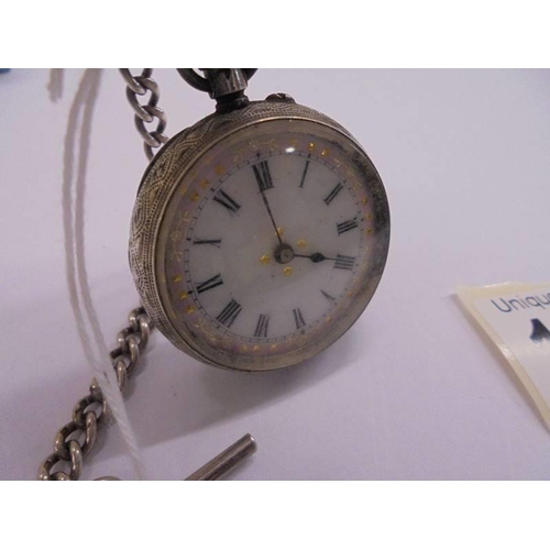 1056 - A Victorian ladies silver fob watch on silver chain, in working order, (chain 17 grams).