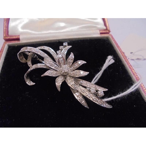 1065 - An exquisite 18ct white gold and diamond floral spray brooch.