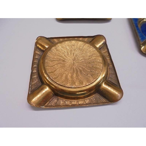 1069 - A copper and enamel ashtray stand with four ashtrays.