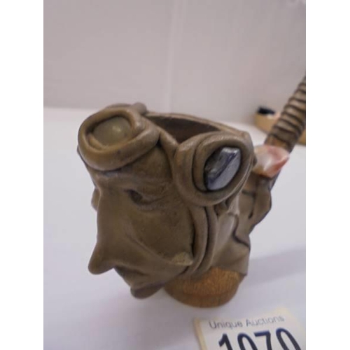 1070 - An unusual vintage pottery pipe of a head impressed with coloured stones.