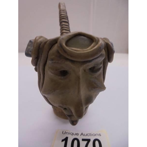 1070 - An unusual vintage pottery pipe of a head impressed with coloured stones.