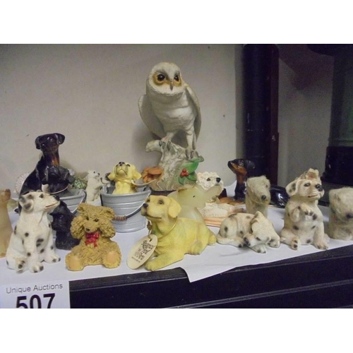 507 - A shelf of dog and other animal figures.