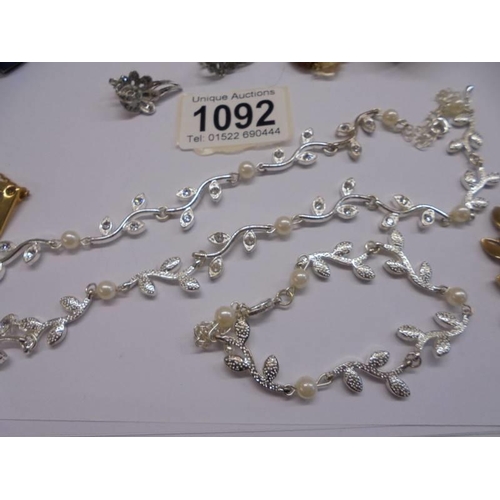 1092 - A mixed lot of costume jewellery including necklaces, earrings, brooches etc., (one necklace a/f).