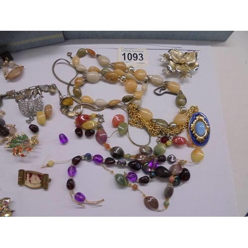 1093 - A jewellery box containing necklaces, brooches, watches etc.,