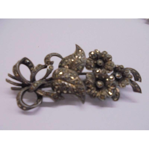 1095 - A silver marcasite flower spray brooch together with an un-marked marcasite brooch and necklace.