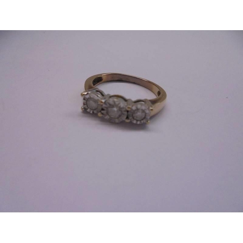 1099 - A three stone diamond ring (tests as 14ct gold) size N half, 2.86 grams.