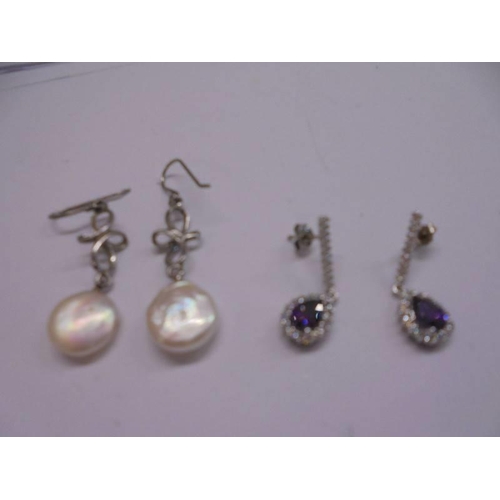 1100 - Four pairs of silver (925) earrings and an un-marked pair of earrings.