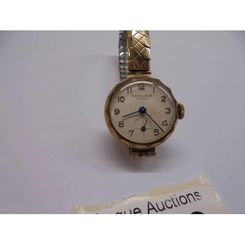 1109 - A ladies 9ct gold Excaliber 17 jewel wrist watch on a yellow metal bracelet.