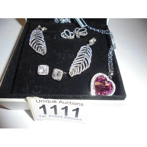 1111 - Three pairs of 'Pandora' silver earrings and a Swarovski crystal pendant.