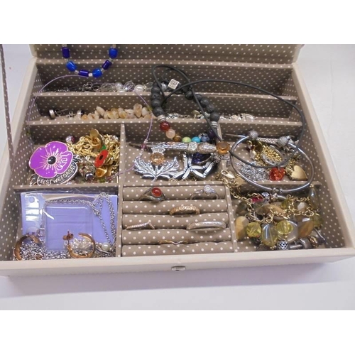 1113 - A jewellery box with a good lot of costume jewellery.