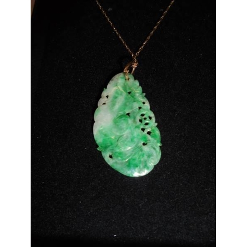 1124 - A jade pendant on a 9ct gold chain.