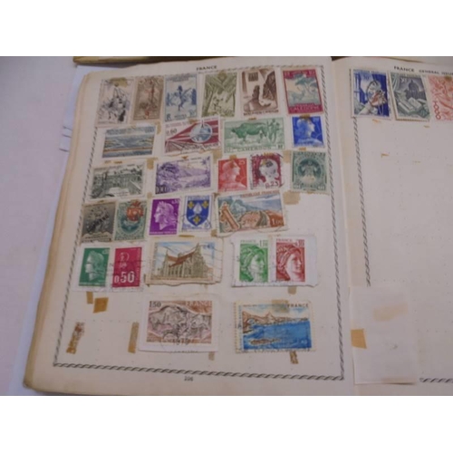 1127 - Two albums of world stamps and a quantity of first day covers.