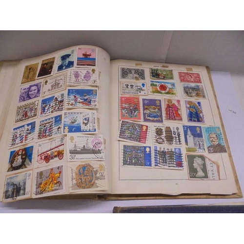 1127 - Two albums of world stamps and a quantity of first day covers.