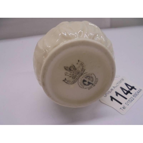 1144 - A Belleek cream jug with black back stamp.