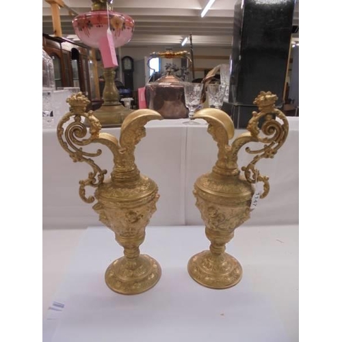 1147 - A pair of heavy gilt metal ewers (one a/f, crack to spout).