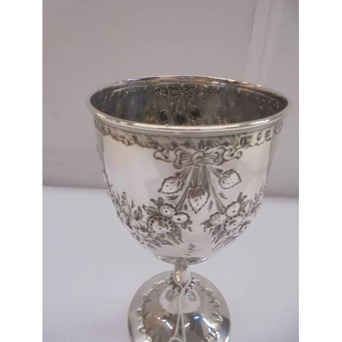 1158 - An embossed silver goblet, hallmarked Birmingham 1868/69, maker S W, 16 cm tall, 5.3 ounces.