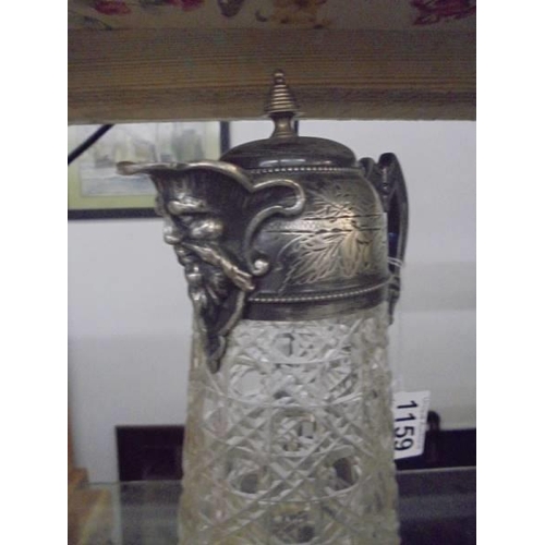 1159 - A hobnail cut glass claret jug with plated top and mask on spout.