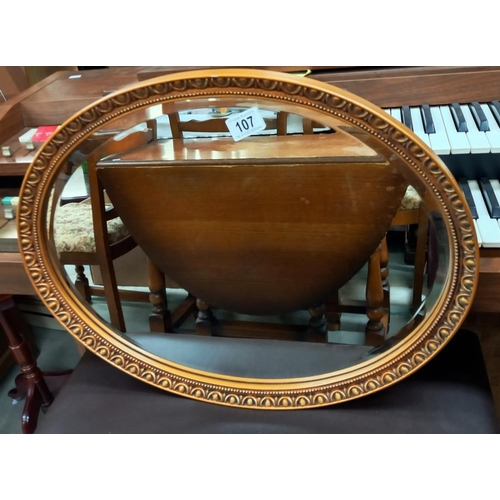 107 - A vintage oval gilt framed bevel edged mirror COLLECT ONLY